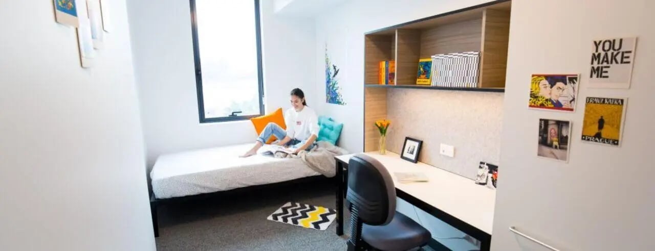 Bed desk chair and shelves student accommodation bedroom at UniLodge Park Central in Brisbane Student Accommodation