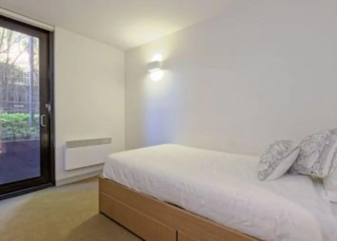Bed with white bedding and patterned pillows Bedroom at Student Living on Riversdale in Melbourne Student Accommodation
