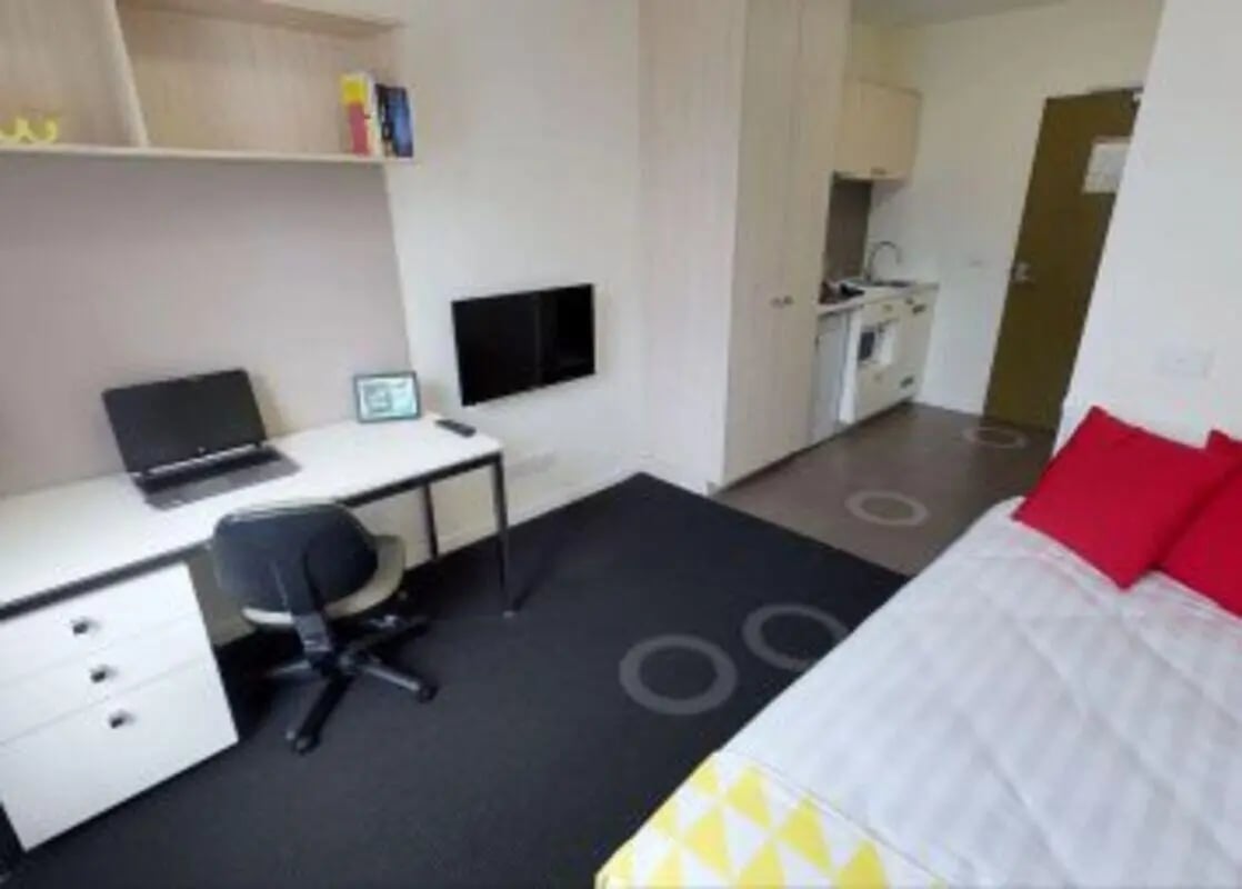 Desk laptop chair TV and bed bedroom at Student Living on Cobden in Melbourne Student Accommodation