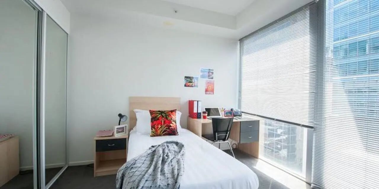 Bed desk chair blinds and closet bedroom at Student Living on Lonsdale in Melbourne Student Accommodation