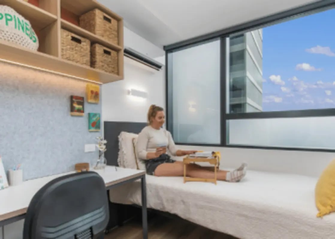 Student study desk and bed near window Bedroom at UniLodge Melbourne Flagstaff in Melbourne Student Accommodation