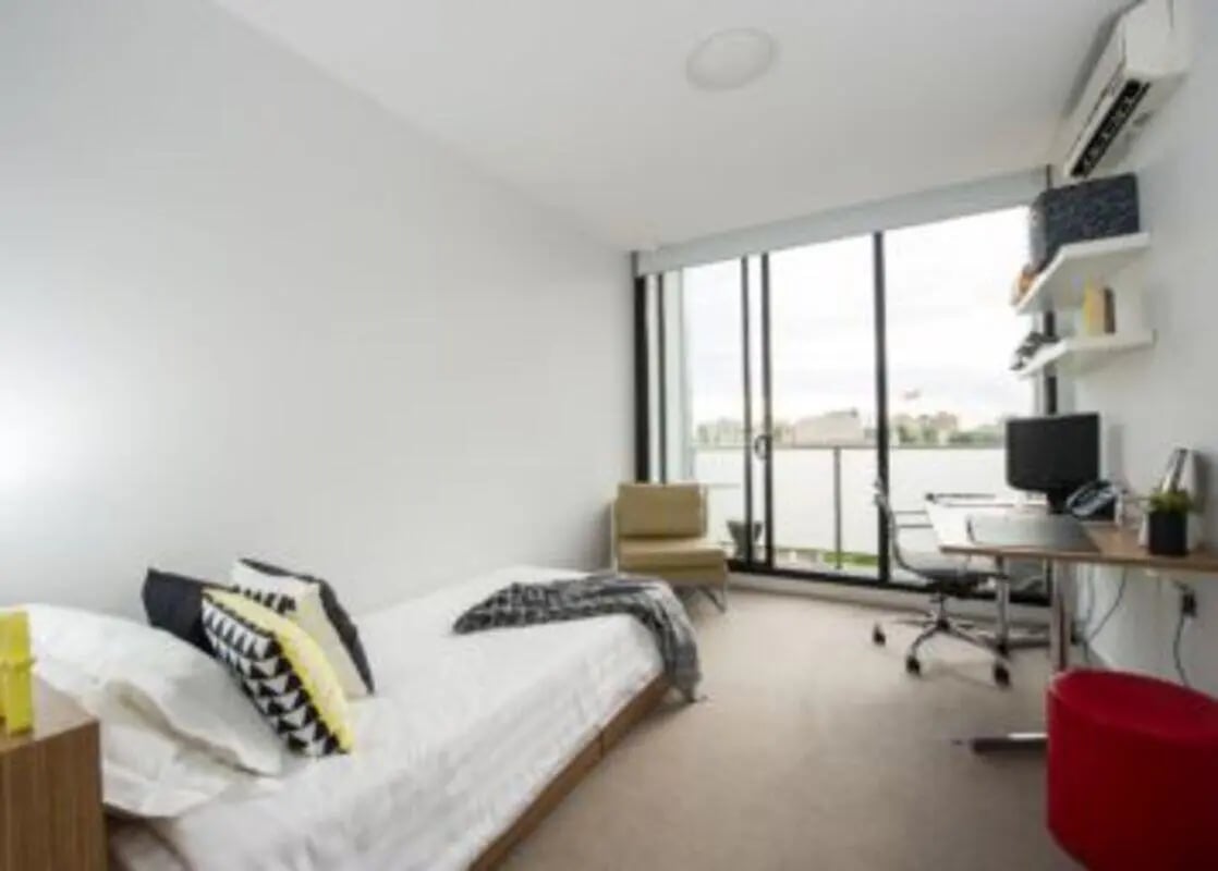 Bed desk chair and window bedroom at Student Living D2 in Melbourne Student Accommodation
