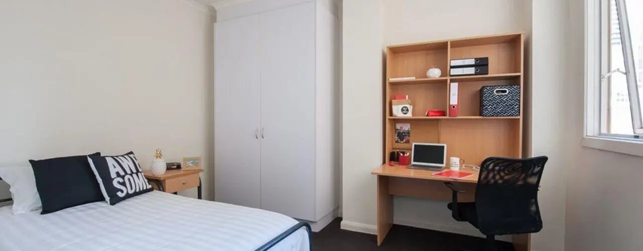 Bed desk closet and chair bedroom at Student Living on Flinders in Melbourne Student Accommodation