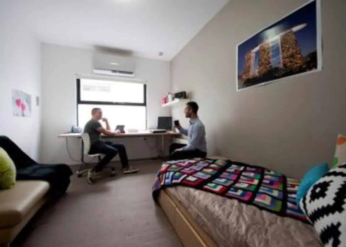 Two students in a furnished bedroom at Student Living D1 in Melbourne Student Accommodation