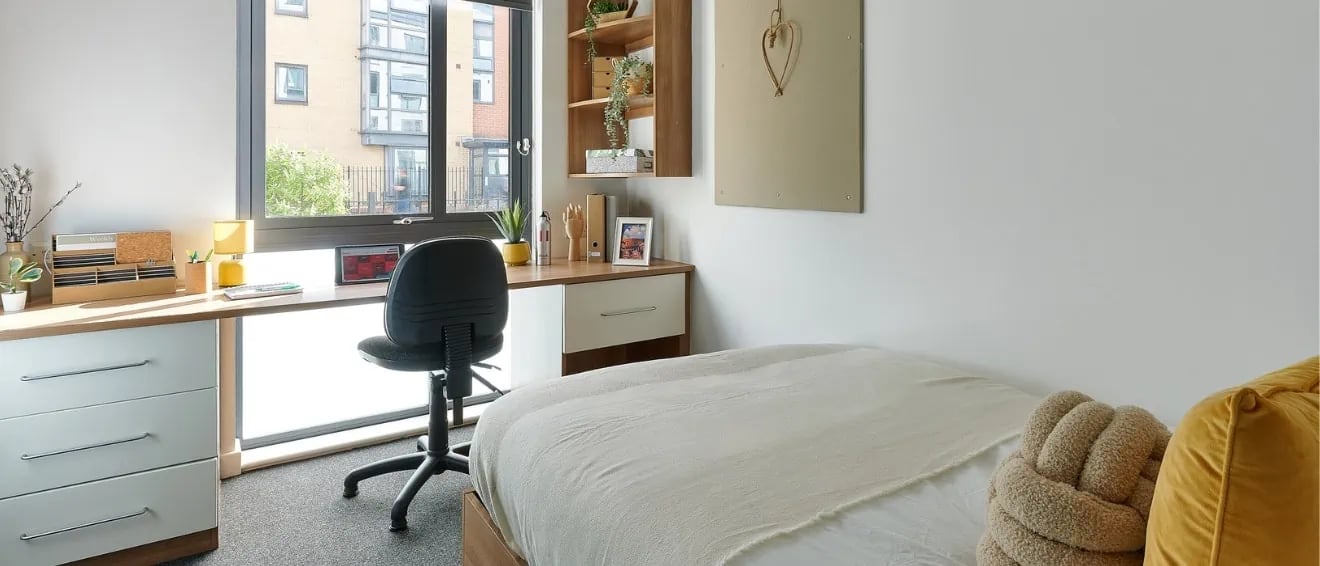 Bed desk chair and drawers bedroom study area at Cavendish Place in Manchester Student Accommodation