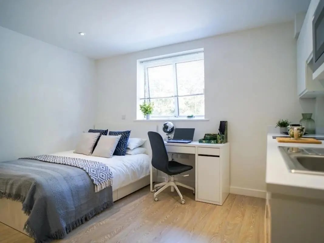 Bed desk chair laptop window sink kitchen bedroom at Orme House in Newcastle Under Lyme Student Accommodation