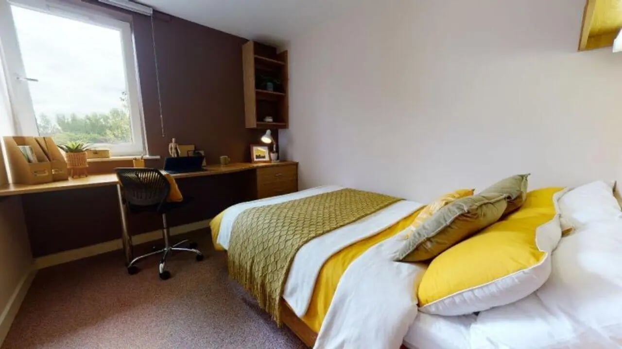 Bed desk and chair with window view bedroom at iQ Leeds in Leeds Student Accommodation