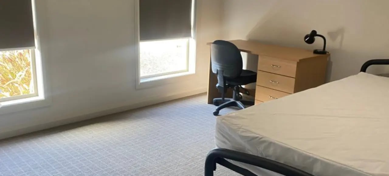 Bed desk chair lamp two windows bedroom at La Trobe University Regional Housing - Mildura in Mildura Student Accommodation