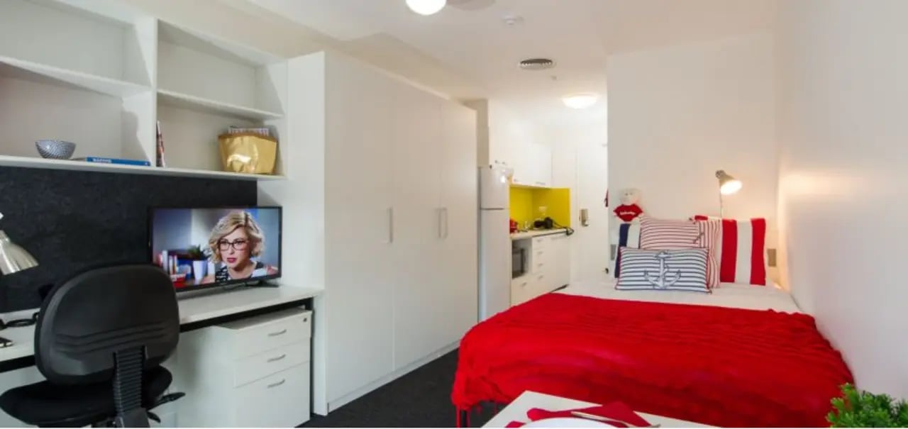 Desk television built-in wardrobe bed kitchen studio apartment at UniLodge Victoria University in Melbourne Student Accommodation