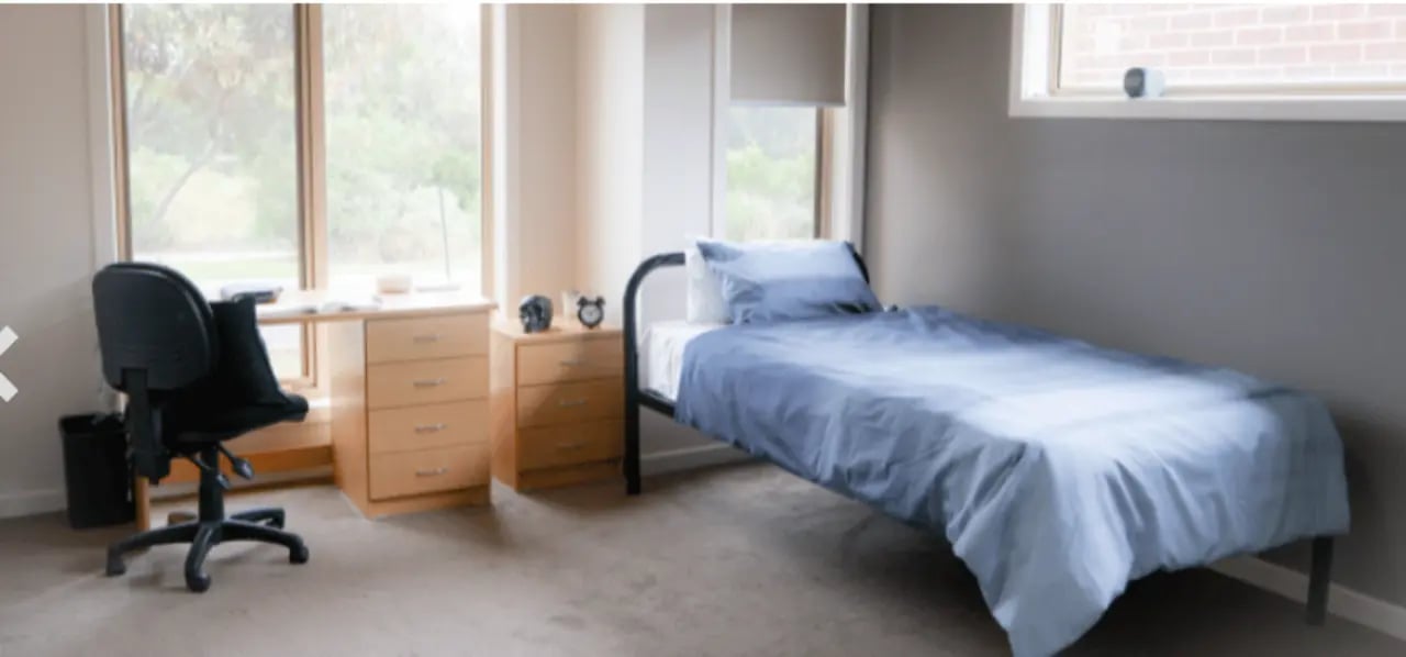 Bed desk chair two drawers study bedroom at La Trobe University Regional Housing - Melton in Melton Student Accommodation