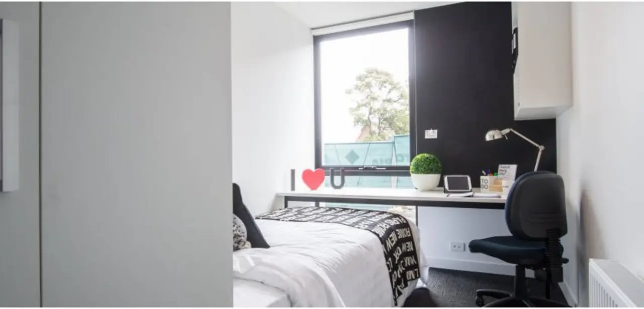 Bed desk chair and plant bedroom at UniLodge Victoria University in Melbourne Student Accommodation