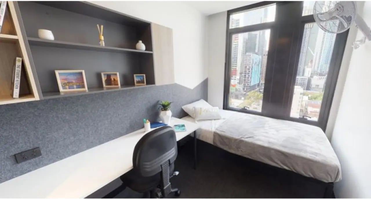 Bed desk shelves and city view bedroom at UniLodge Lincoln House in Melbourne Student Accommodation