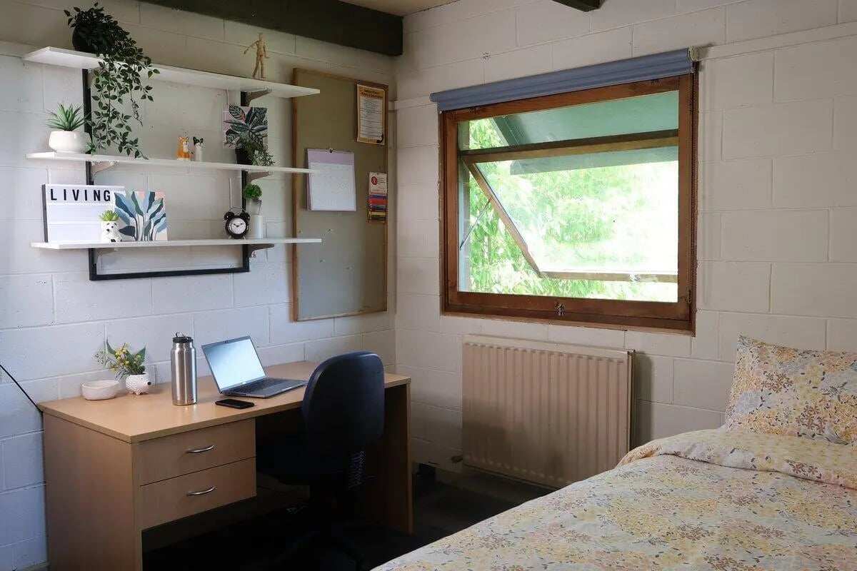 Desk laptop chair bed and shelves bedroom at La Trobe University - Units in Melbourne Student Accommodation