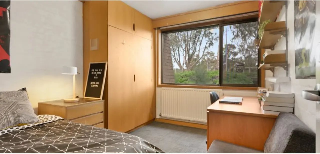 Bed desk lamp wardrobe near window bedroom at La Trobe University - Chisholm College in Melbourne Student Accommodation