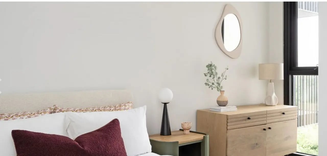Bedside table lamp and dresser bedroom at Dickson Village Apartments in Canberra Student Accommodation