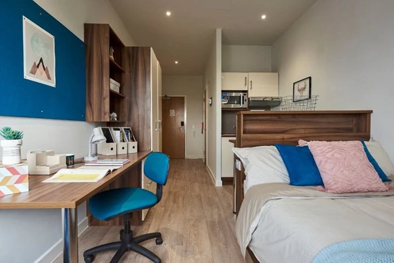 Desk chair bookshelf bed kitchen area bedroom at Central Studios Reading in Reading Student Accommodation