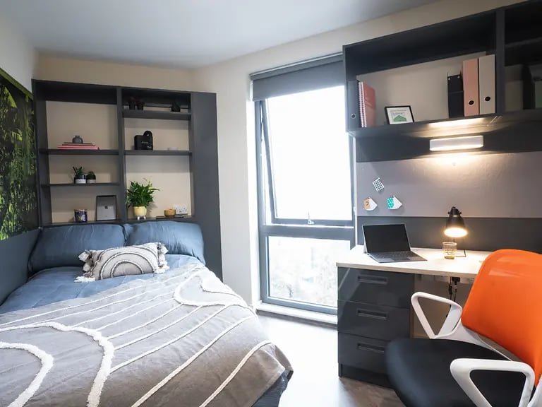 Bed shelves desk laptop and chair bedroom at Oxford House - Newcastle in Newcastle Upon Tyne Student Accommodation
