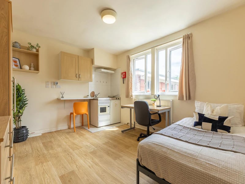 Bed kitchen desk and chair student accommodation studio at Brooke Hall in London Student Accommodation