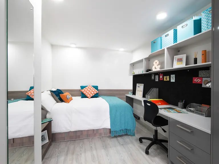 Bed desk and shelves bedroom study area at Livin Cardiff in Cardiff Student Accommodation