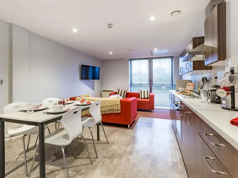 Dining table kitchen couches and TV living area at Mary Parker House in Plymouth Student Accommodation