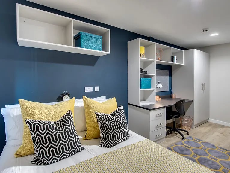Bed with pillows desk and wardrobe bedroom at Riverside Quay in Stirling Student Accommodation