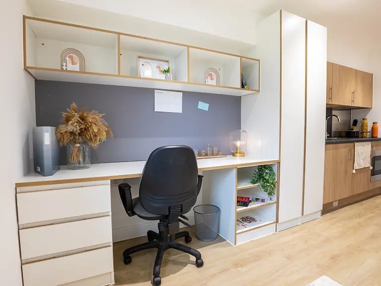 Desk chair storage shelves and kitchen area study at Elmstead Place in Colchester Student Accommodation