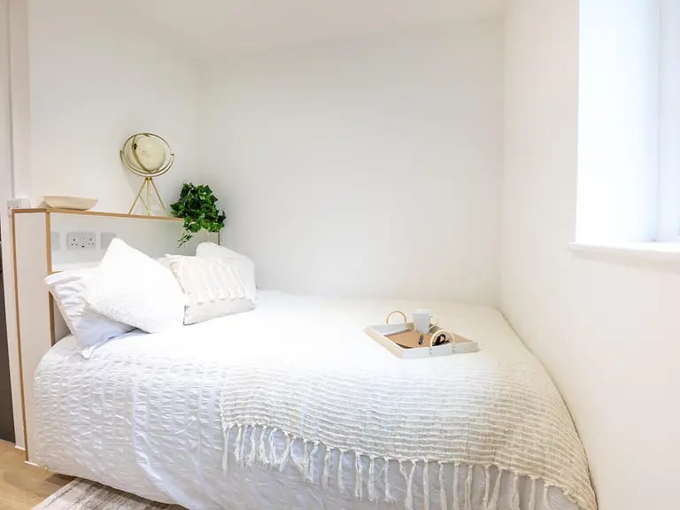 Bed with white bedding and tray bedroom at Elmstead Place in Colchester Student Accommodation