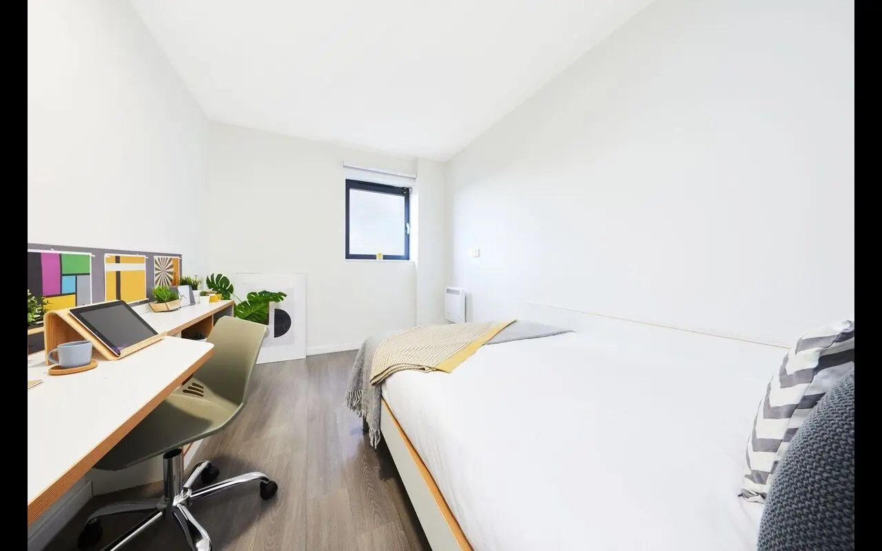 Bed desk and chair student accommodation bedroom at Collegiate Merlin Heights in Leicester Student Accommodation