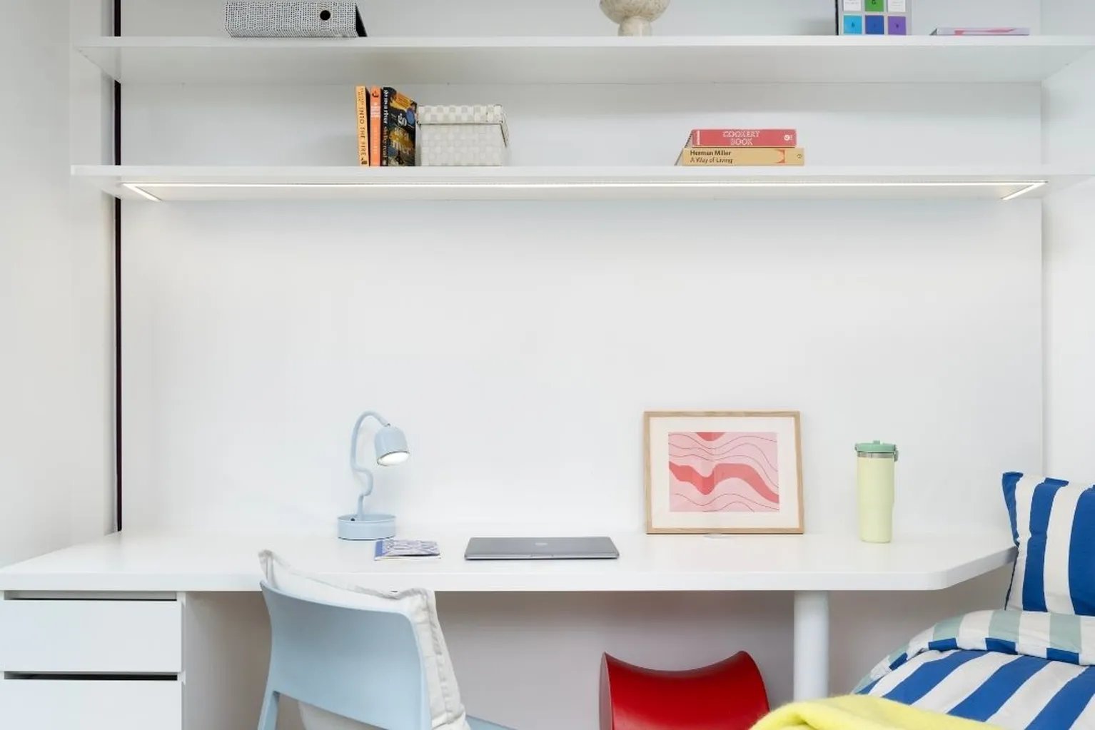 Desk with laptop lamp and framed art Study area at Scape Wembley in London Student Accommodation
