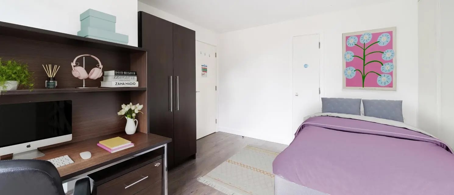 Desk headphones computer bed and painting bedroom at Chapter Spitalfields in London Student Accommodation