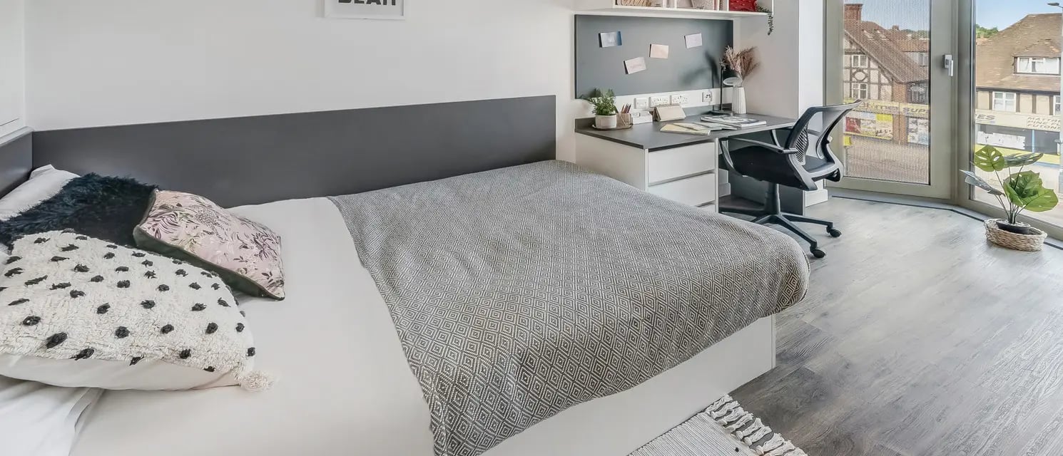 Bed desk chair plant student accommodation bedroom at Chapter White City in London Student Accommodation