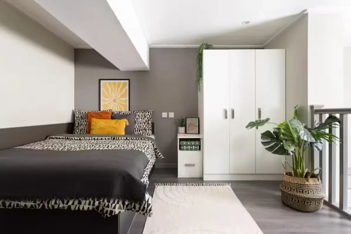 Bed with patterned bedding large white wardrobe bedroom at Causeway View in Aberdeen Student Accommodation
