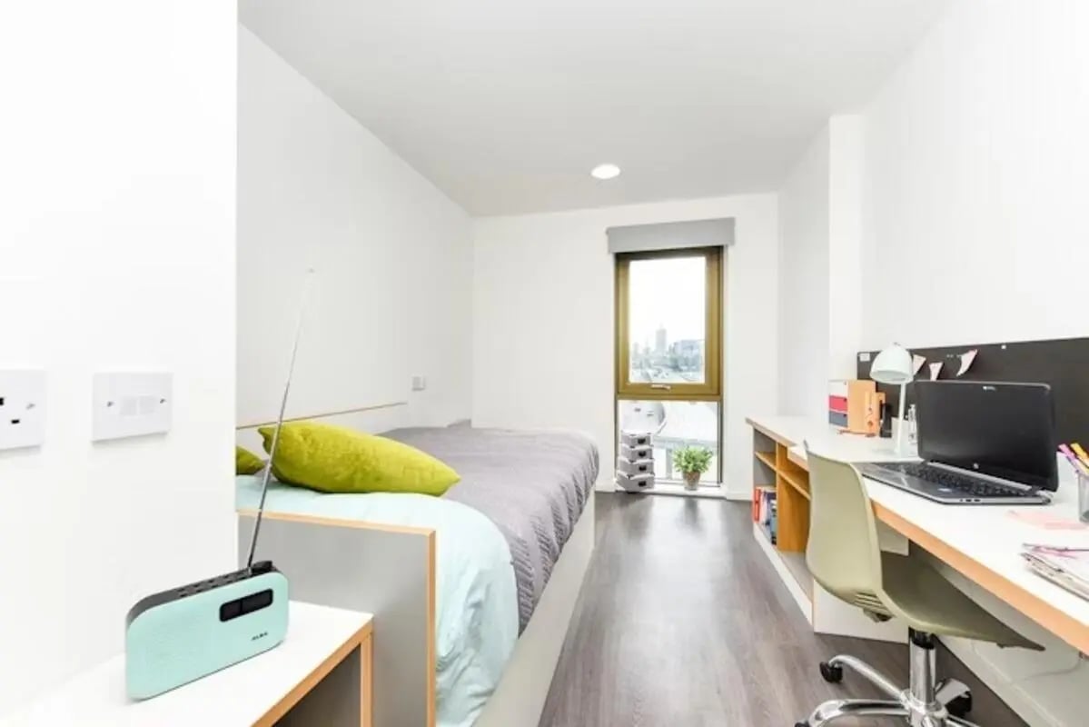 Bed desk laptop radio and window bedroom at Byrom Point in Liverpool Student Accommodation