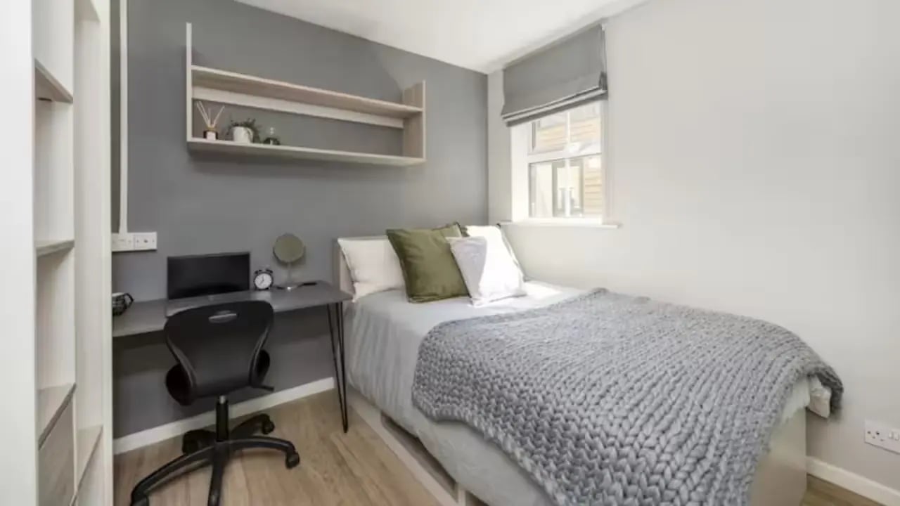 Bed desk chair shelves with laptop and books bedroom at Emily Davies in Southampton Student Accommodation