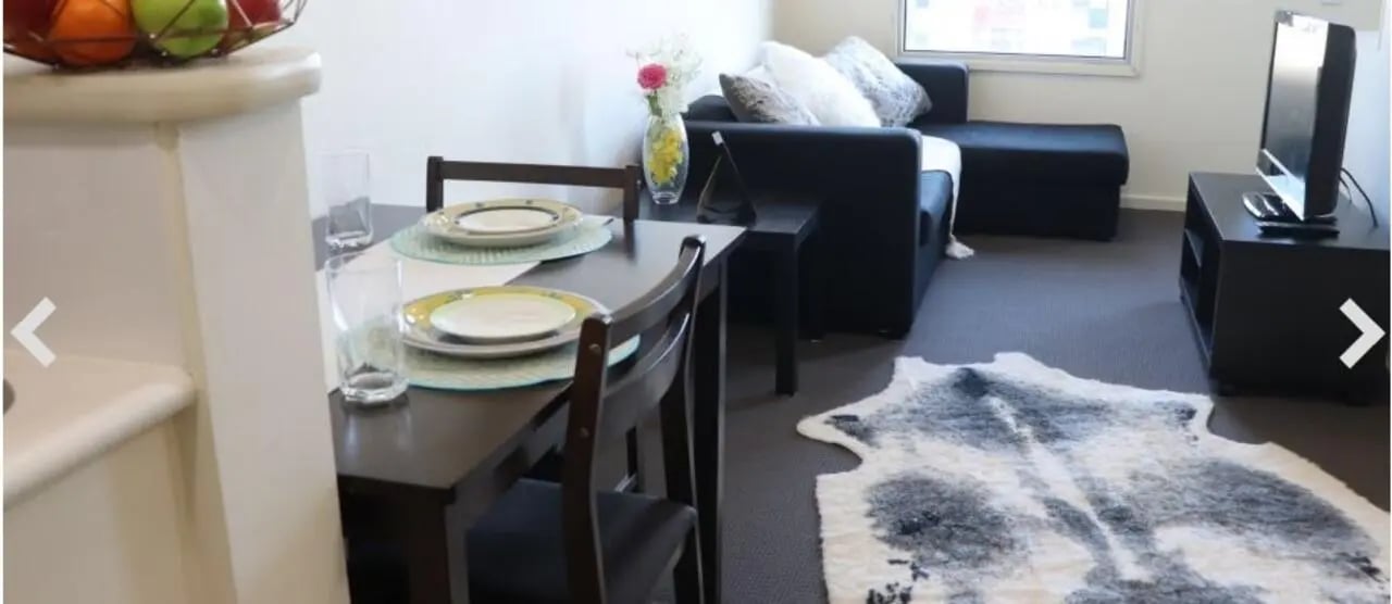 Dining table with chairs and sofa living room at Student Living - 570 Lygon in Melbourne Student Accommodation