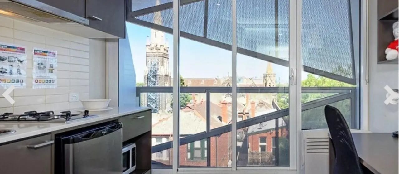 Kitchen with microwave, fridge, and city view at Student Living - Vivida in Melbourne Student Accommodation