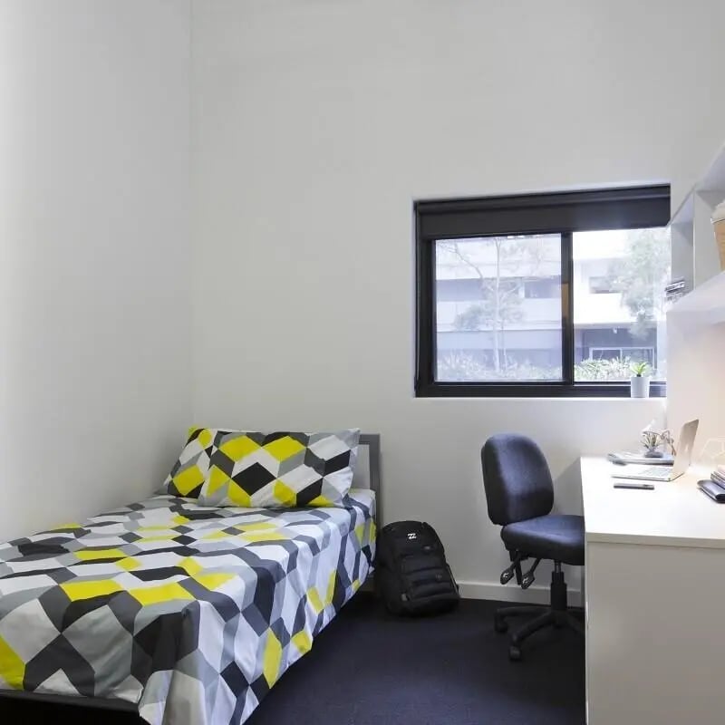Bed desk chair and backpack bedroom at UNSW Village in Sydney Student Accommodation