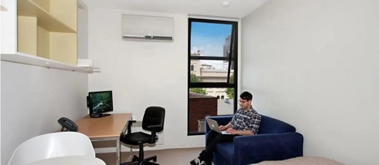 Desk computer chair couch laptop study area at Student Living On Campus in Melbourne Student Accommodation