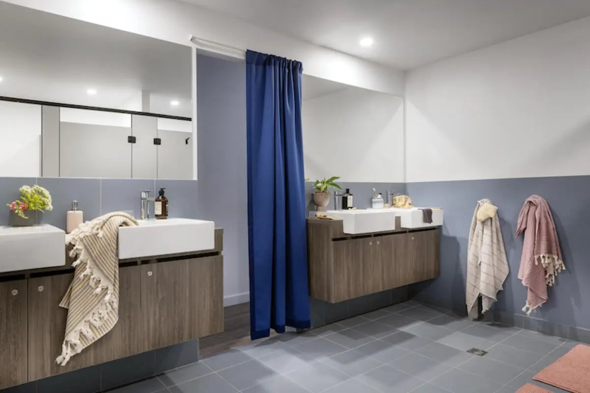 Modern sinks with wooden cabinets and towels bathroom at Campus Perth in Perth Student Accommodation