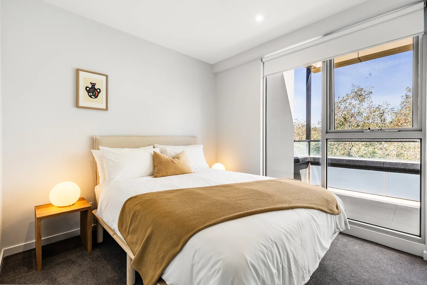 Bed with white linens brown blanket artwork Bedroom at UKO Royal Park in Melbourne Student Accommodation
