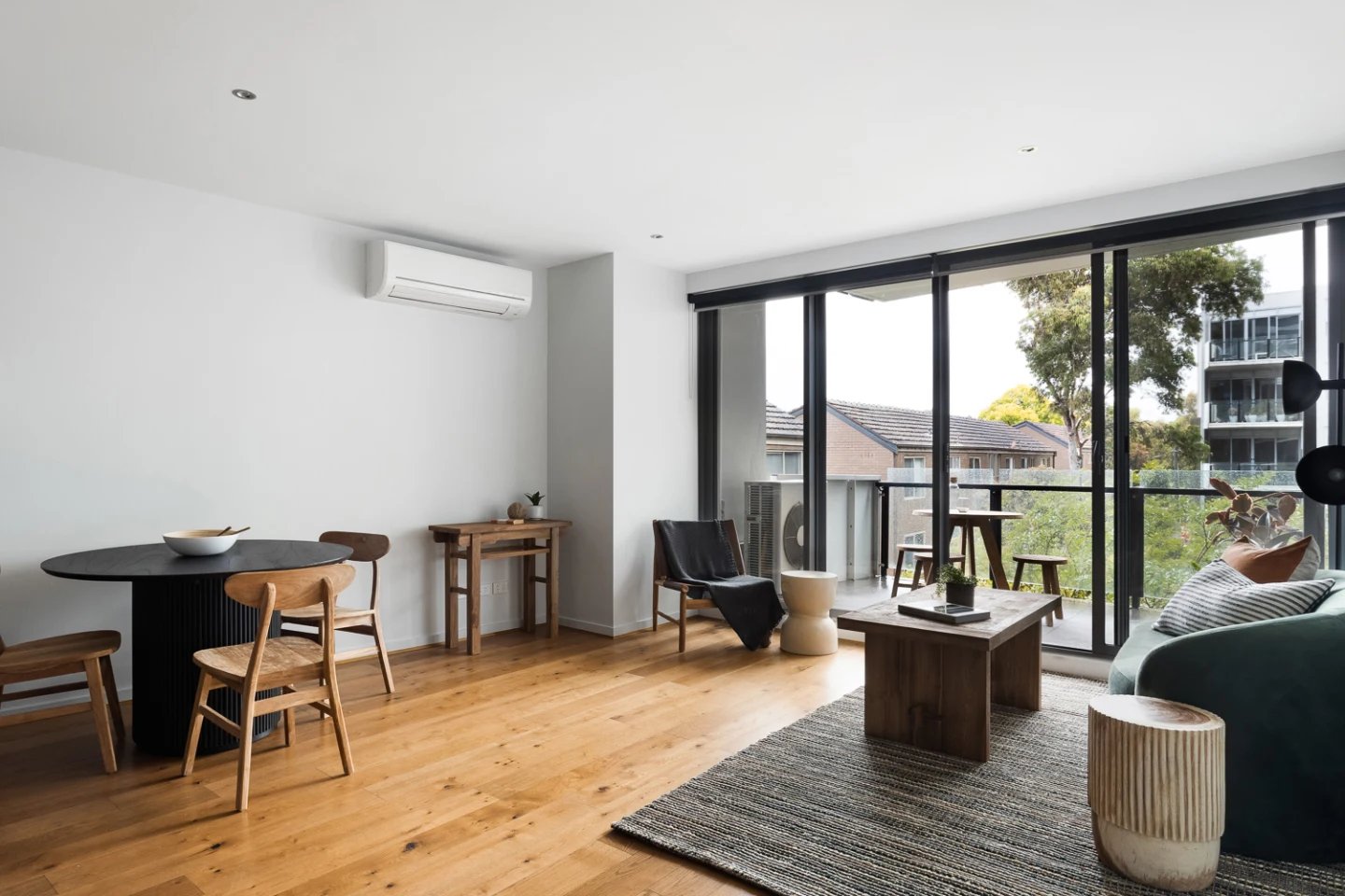 Dining table chairs air conditioner living room at UKO Royal Park in Melbourne Student Accommodation