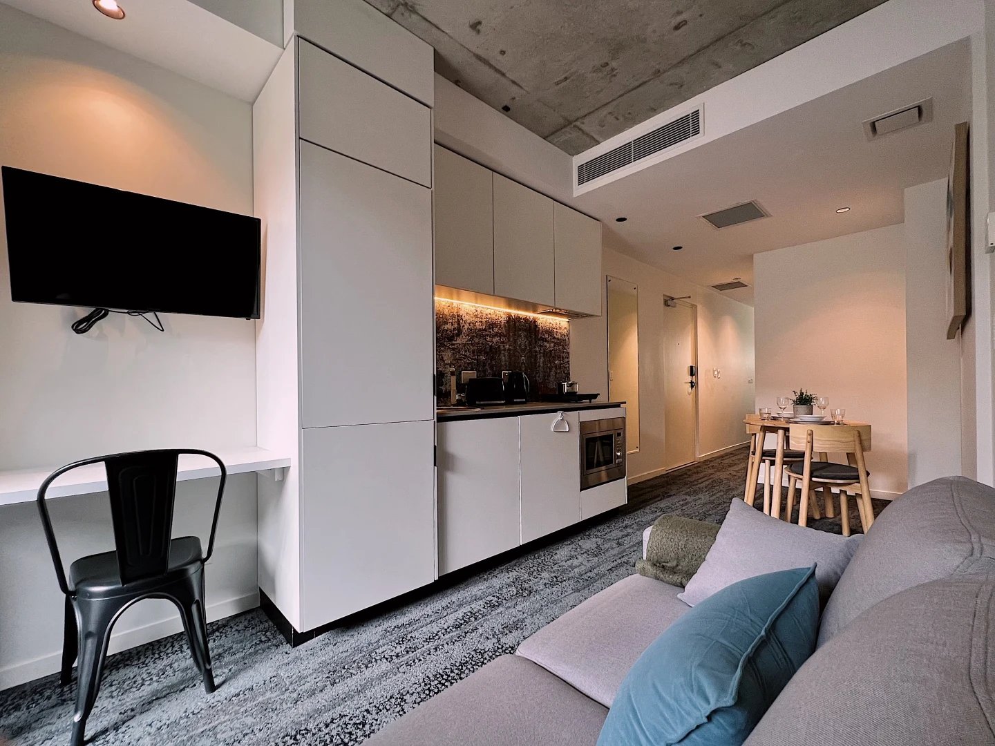 TV desk kitchen dining area sofa living room at UKO Surry Hills in Sydney Student Accommodation
