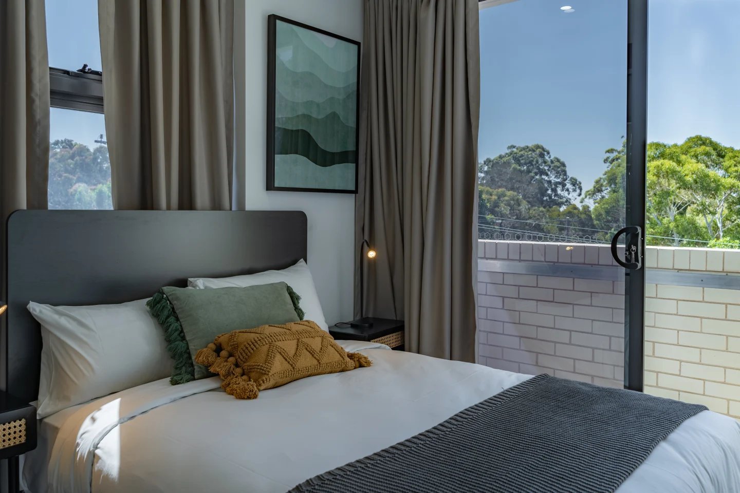 Bed pillows artwork and curtains bedroom at UKO Sutherland in Sydney Student Accommodation