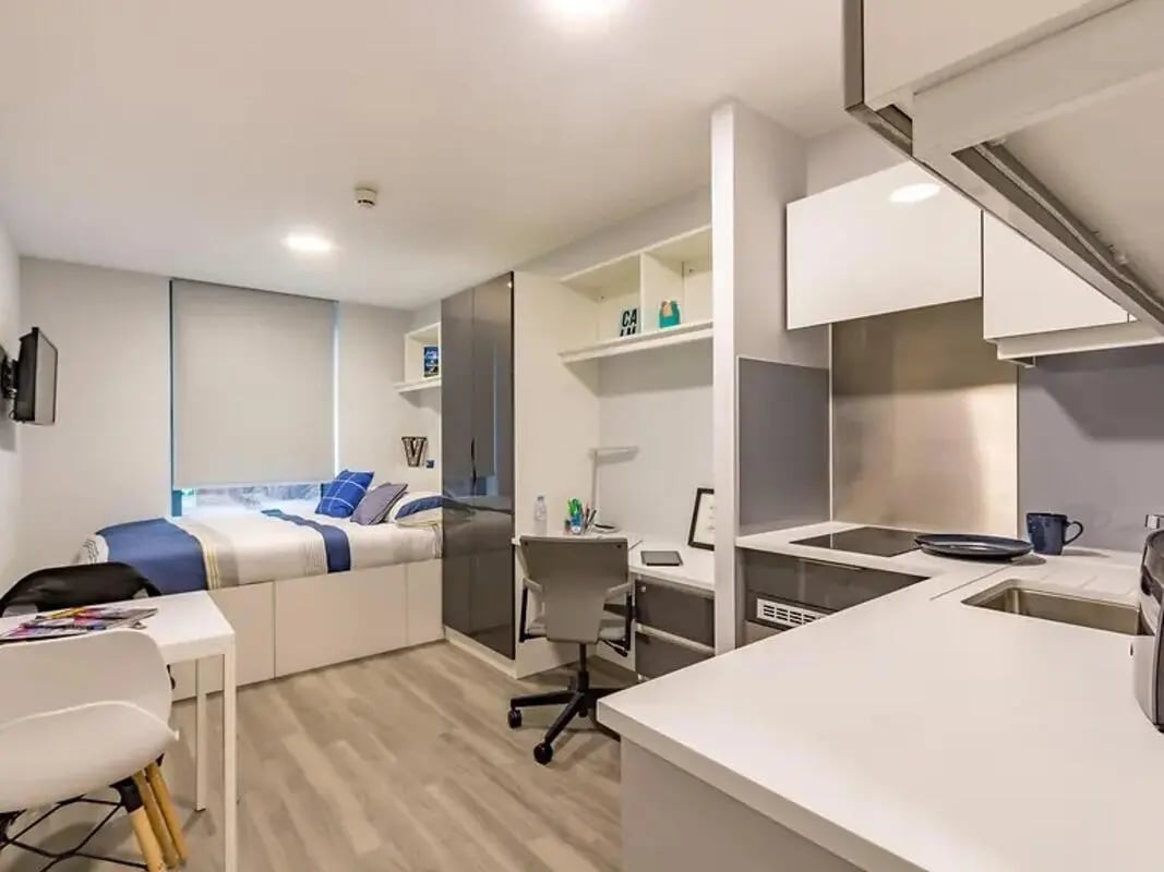Bed desk and kitchen area studio apartment at ViBe Student Living in Kingston Upon Thames Student Accommodation