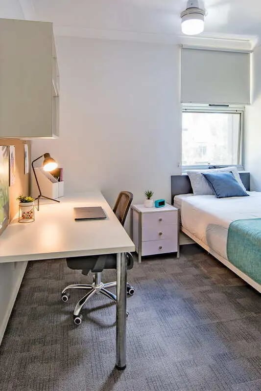 Desk lamp chair laptop bedside table bed bedroom at Iglu Kelvin Grove in Brisbane Student Accommodation