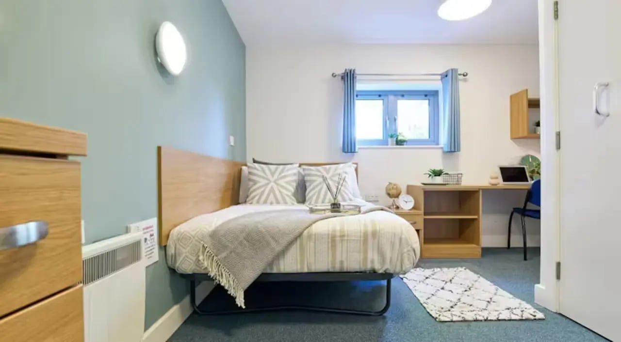 Bed desk chair window and rug bedroom at Barker House in Newcastle Upon Tyne Student Accommodation