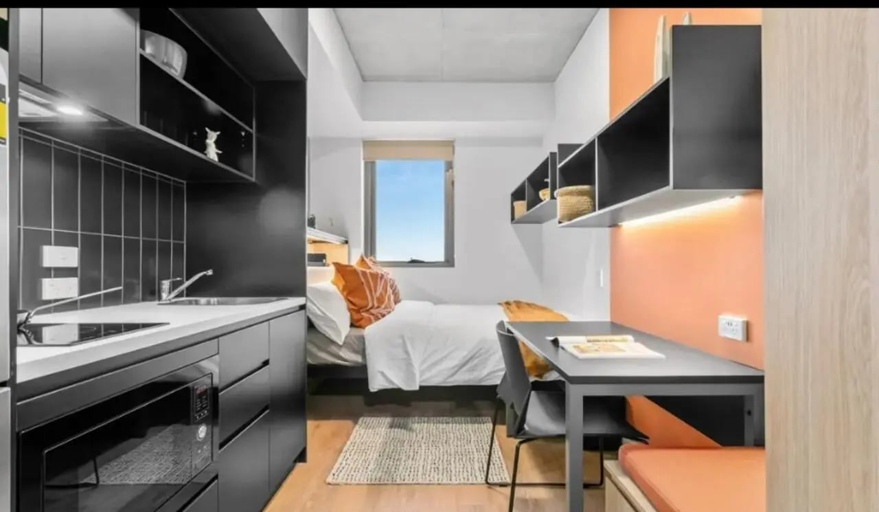 Kitchen bed desk and shelves bedroom at The Switch Adelaide in Adelaide Student Accommodation