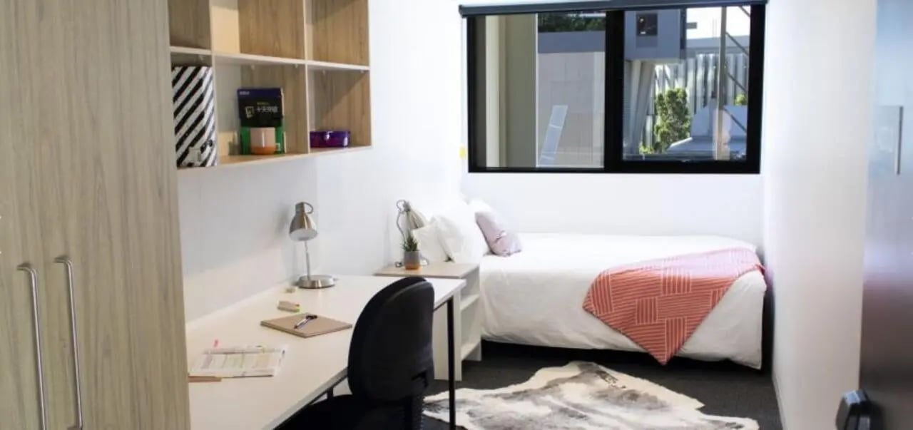Bed desk shelves and rug bedroom at Unilodge South Bank in Brisbane Student Accommodation