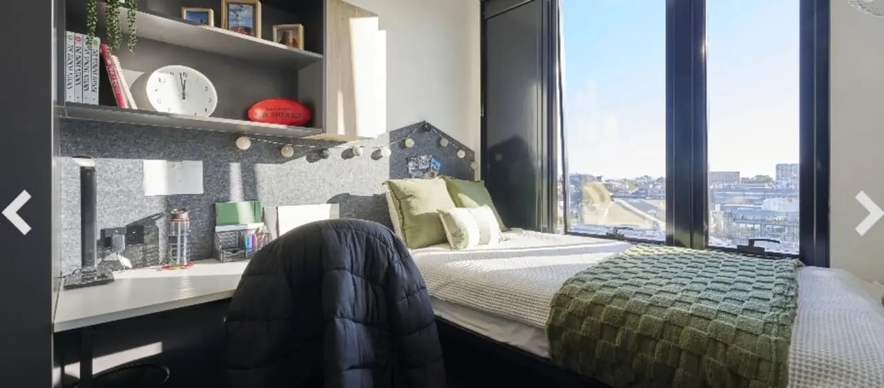 Bed with desk and large window bedroom at UniLodge Lincoln House in Melbourne Student Accommodation