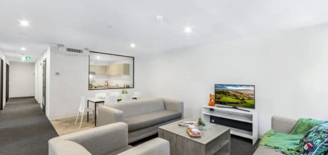 Sofa coffee table TV and dining area living room at Unilodge South Bank in Brisbane Student Accommodation